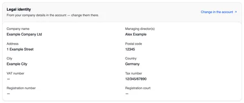 The “Legal identity” card — “From your company details in the account — change them there.” and, top right, the link “Change in the account” — with company name and managing director side by side, below them in two columns address, postal code, city, country, VAT number, tax number, registration number and registration court.