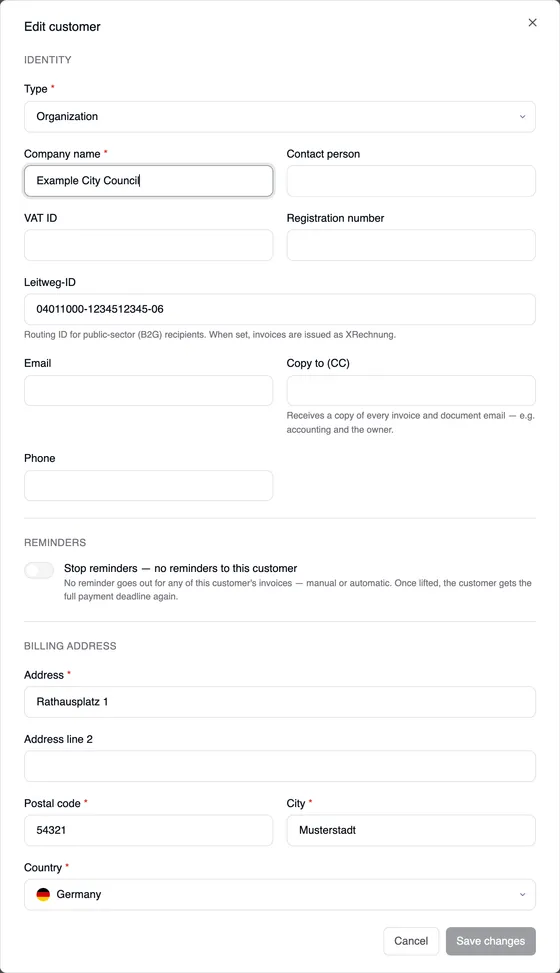 The “Edit customer” window for Example City Council: Type Organization, the Leitweg-ID field with 04011000-1234512345-06 and the hint “Routing ID for public-sector (B2G) recipients. When set, invoices are issued as XRechnung.”, below it Email, Copy to (CC), Phone, the Reminders section and the billing address.